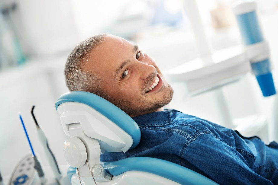 Man in dentist chair smiling